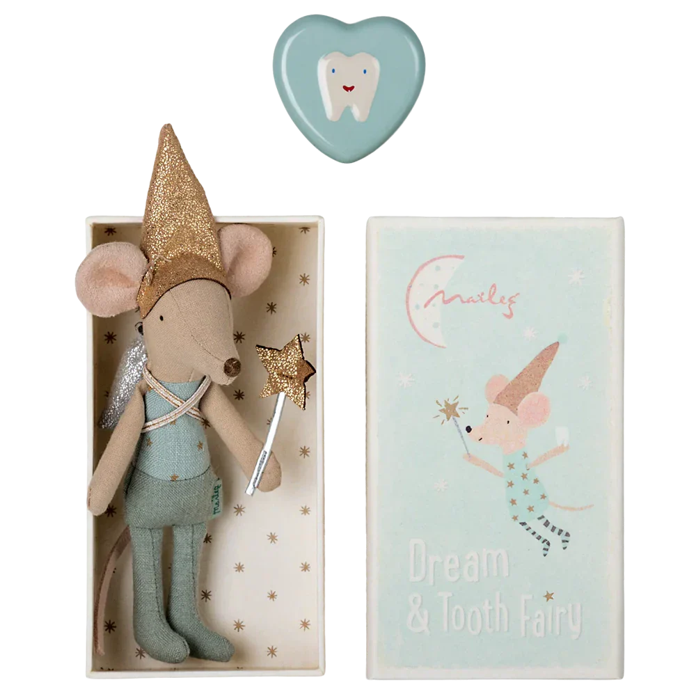 A small plush mouse by Maileg, dressed as a tooth fairy with a glittery hat and wings, rests in a box labeled "Maileg Tooth Fairy Mouse in Matchbox, Blue," perfect for holding a special tooth box. A heart-shaped item is placed lovingly above the box, creating an enchanting scene ideal for sweet dreams.