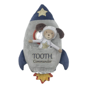 The MON AMI Tooth Commander Spaceship Pillow and Doll Set by Mon Ami features a plush rocket design with "Tooth Commander" text and includes a toy dog in a space suit peeking from the pocket—making it a cozy companion for little adventurers.