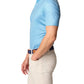 A person wearing a Johnnie-O Double Eagle Polo in light blue and beige pants is standing with a hand in their pocket against a plain background, showcasing the Johnnie-O Featherweight Collection.