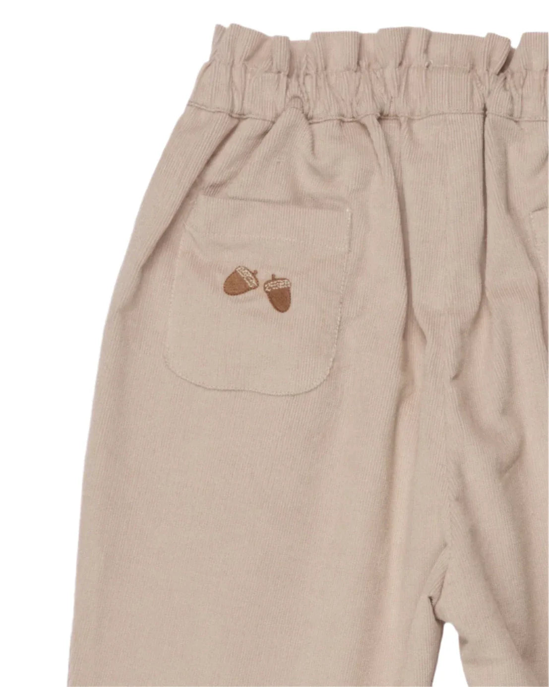 The Early Sunday Adrin Trouser is a pair of beige cotton corduroy pants featuring an elastic waistband, a side pocket with two embroidered acorns, and designed in a straight-leg fit by the Early Sunday brand.