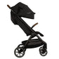 A Nuna TRVL lx Stroller by Nuna, featuring a sleek black design, brown handle grips, a canopy for shade, a practical storage basket underneath, and the convenience of a one-handed fold.