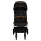 Experience the Nuna TRVL lx Stroller by Nuna, designed for compact freedom. This black stroller features a canopy, padded seat, safety harness, and a wooden safety bar. Its four wheels ensure smooth rides, while the one-handed fold mechanism offers ultimate convenience for on-the-go parents.