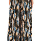 Someone wearing Ulla Johnson's Sawyer Pant, a flowing and patterned 100% silk piece with abstract designs in blue, black, and beige.