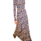 A person wearing the Ulla Johnson Naia Midi Dress, a long-sleeve, ankle-length dress with a blue, beige, and black ikat print; face is not visible.