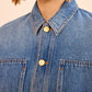 A close up of a person's shirt, featuring the blue denim Arquette Jacket by Ulla Johnson in a relaxed fit.