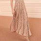 A person stands on a carpeted floor in strappy heeled sandals, wearing the Ulla Johnson Clio Knit Midi Skirt—a pleated, multicolored striped design with an elastic waist.