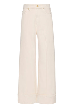 The Genevieve Stretch Jean by Ulla Johnson features wide legs, a high waist, front seams, cuffed hems, belt loops, and front/back pockets in white denim, shown against a plain white background.