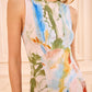 A woman is shown from the waist up wearing Ulla Johnson’s sleeveless Lana Ruched Jersey Dress, featuring an abstract multicolored watercolor print inspired by Helen Frankenthaler.
