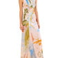 The Ulla Johnson Lana Ruched Jersey Dress is a sleeveless, floor-length style featuring a multicolor abstract print inspired by Helen Frankenthaler and ruched waist detail. Model is shown standing facing forward.