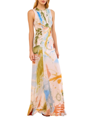 The Ulla Johnson Lana Ruched Jersey Dress is a sleeveless, floor-length style featuring a multicolor abstract print inspired by Helen Frankenthaler and ruched waist detail. Model is shown standing facing forward.