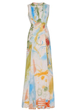 The Lana Ruched Jersey Dress by Ulla Johnson is a sleeveless, floor-length style with a fitted waist and abstract blue, green, orange, and yellow watercolor print—its expressive design inspired by Helen Frankenthaler.