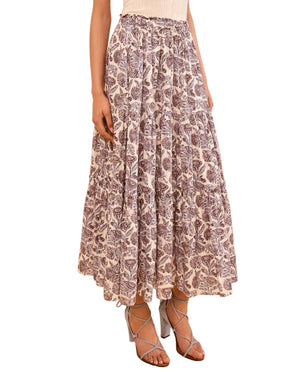 Someone in the Ulla Johnson Nessa Skirt, a cream and purple cotton-blend skirt featuring an elastic waist and tiered design, paired with strappy heeled sandals.