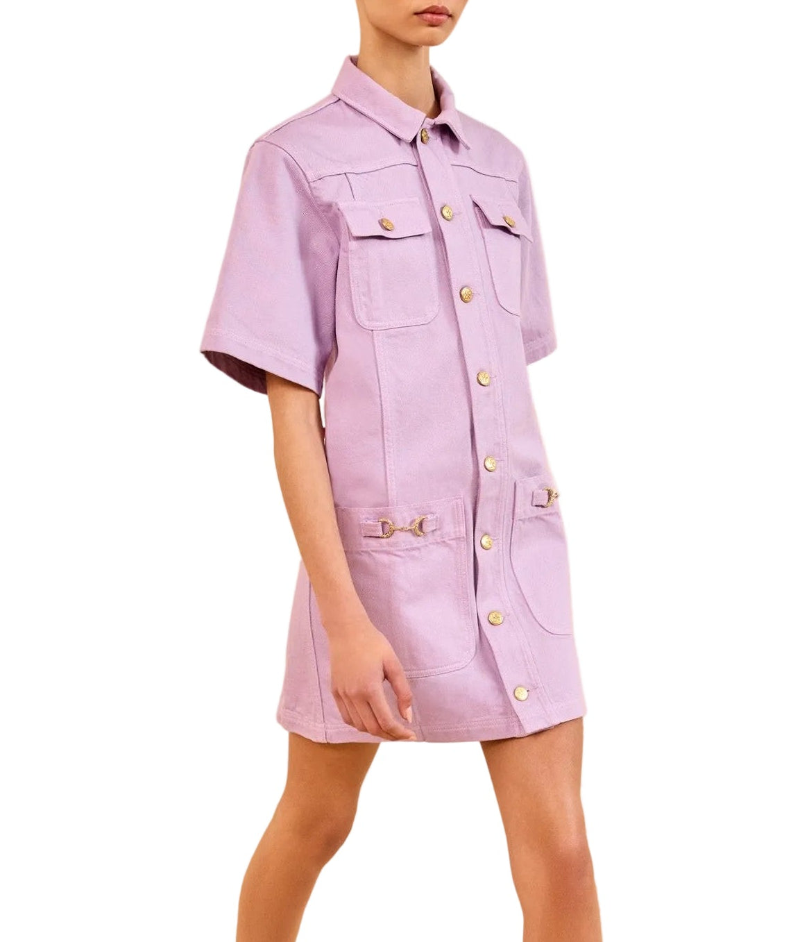 A person wearing a Wisteria lavender Ulla Johnson Painters Dress with a shirt-inspired silhouette, front pockets, and gray heels with bow details.