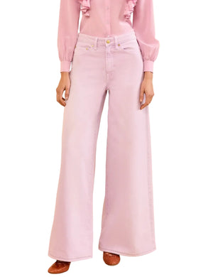 A woman wearing Ulla Johnson's Zephyr Jean, featuring a wide leg silhouette in a soft lavender wash.