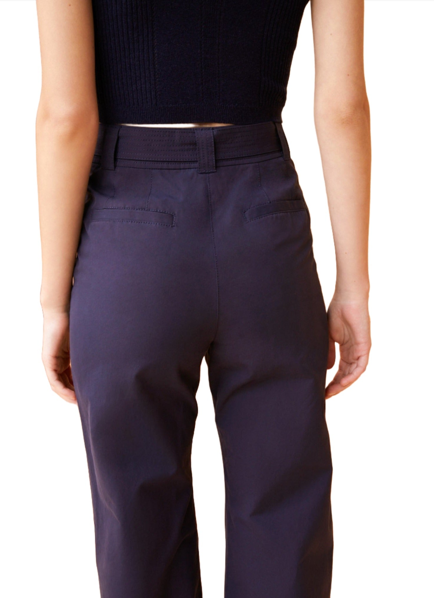 A person wearing midnight blue Ulla Johnson Daya Pant and a black sleeveless top, shown from the back.