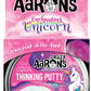 Crazy Aaron's Thinking Putty, Enchanting Unicorn edition, features glow-in-the-dark pink putty. It's safe and non-toxic for kids, packaged with a unicorn image and a sensory integration warning for children under 3 years.