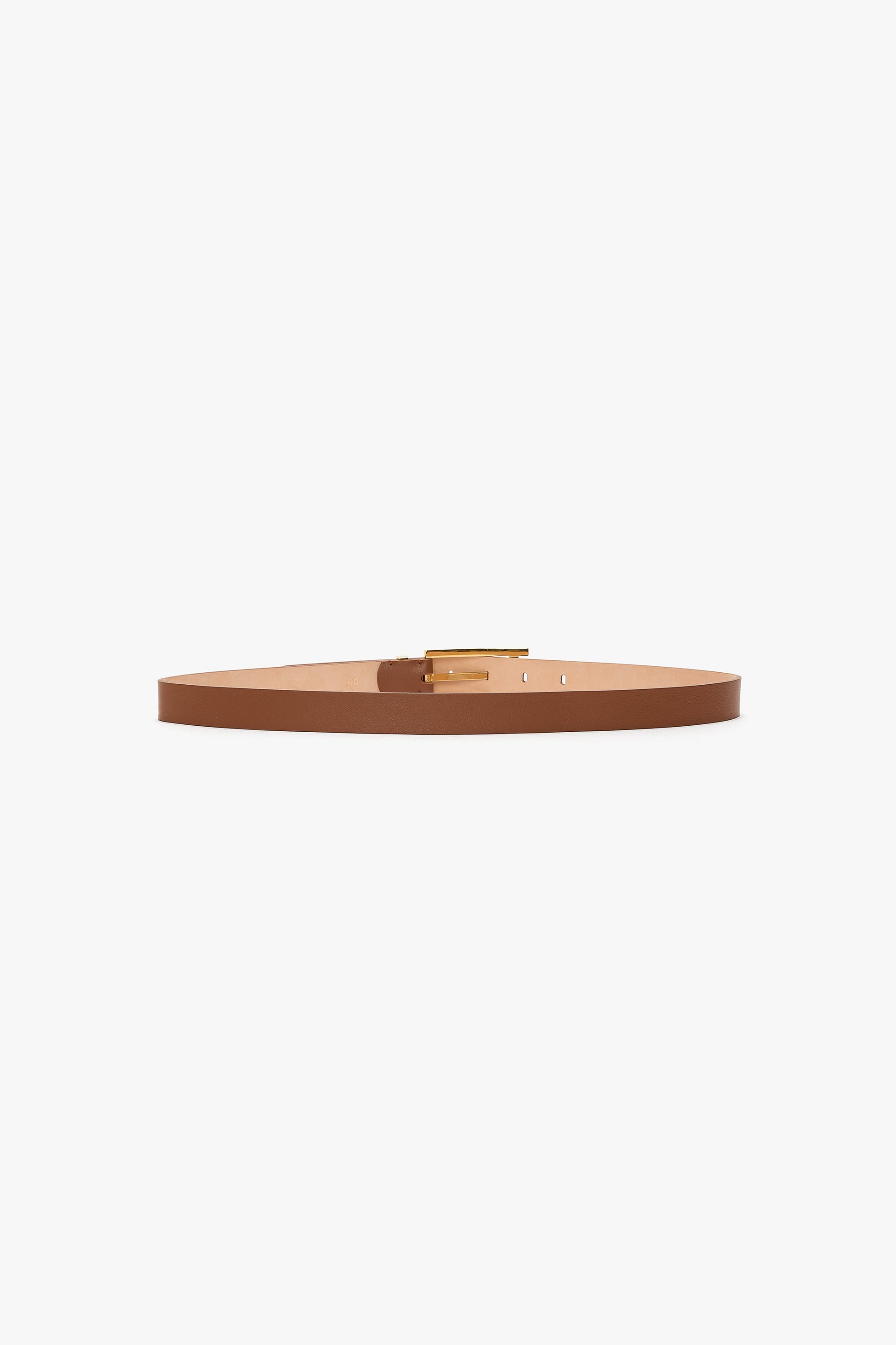 The Pin Buckle Dorian Belt by Victoria Beckham is a slim, dark tan calf leather belt featuring a small gold rectangular pin buckle, shown laid flat on a white background.