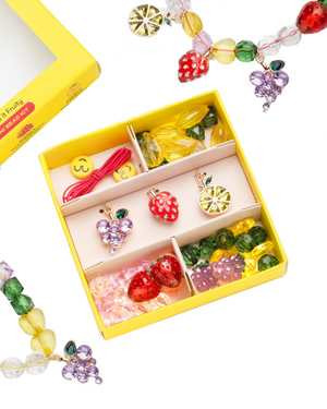 The Make It Fruity Mini Bead Kit by Super Smalls features colorful fruit-inspired charms and berry-bright beads—strawberries, grapes, lemons, and smiley faces—all neatly organized in compartments.