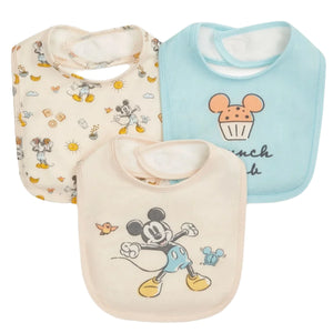 The Magnetic Me Baby Modal Bib 3-Pack, made from soft TENCEL™ modal and featuring Mickey Mouse designs in cream, beige, and blue, is shown arranged overlapping on a white background.