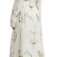 A person is shown from the back wearing the Erdem Long Sleeve Silk Midi Dress With Tie Waist Detail, featuring a light floral print, paired with beige platform sandals with ribbon ties.