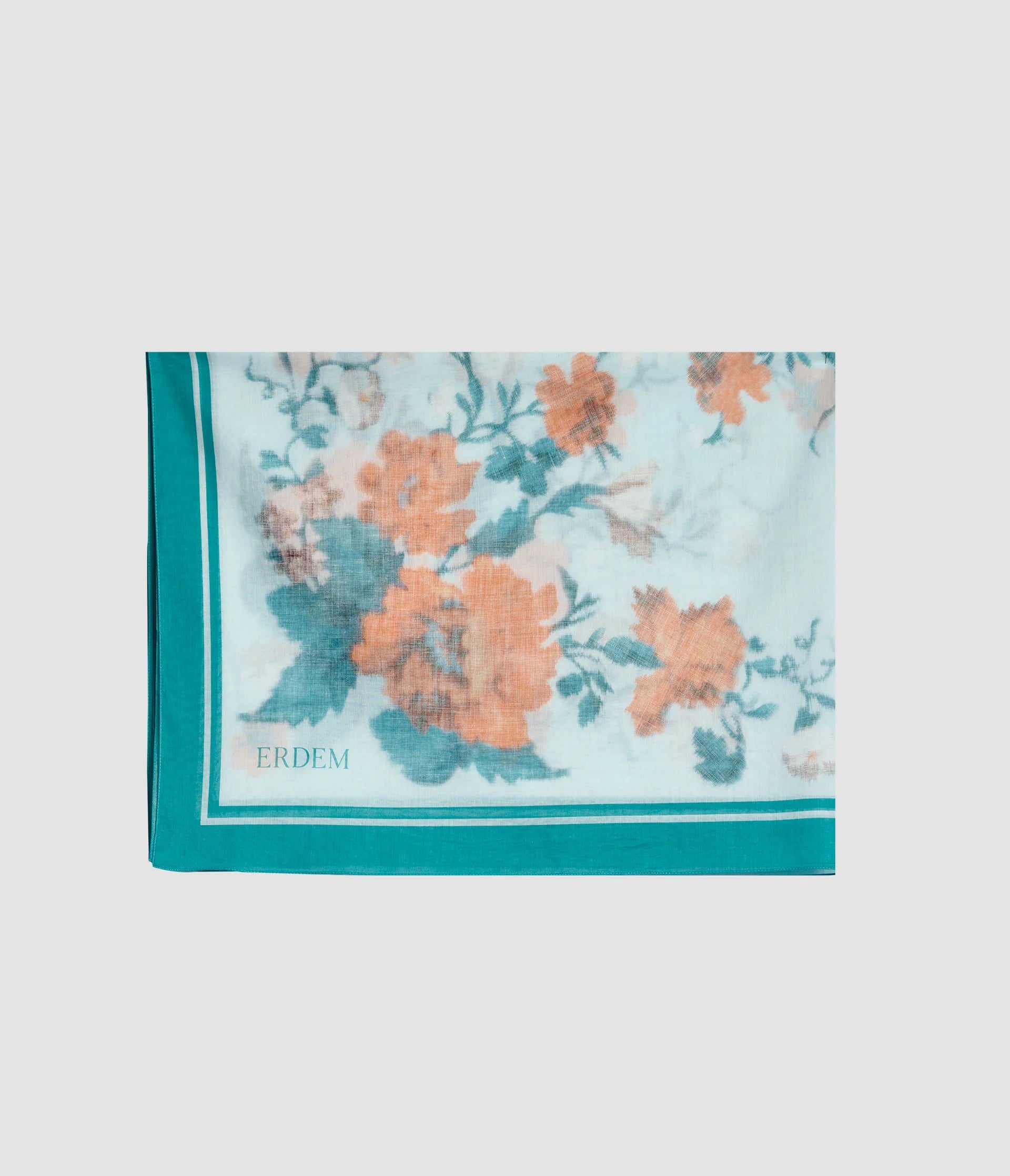 The Trailing Poppy Pareo by Erdem is a light blue scarf with orange and green poppy floral print, a teal border, and "ERDEM" in one corner, crafted from a soft silk-modal blend.