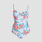 The Erdem Trailing Poppy One Piece is a blue one-piece swimsuit with moulded cups and adjustable straps, showcasing a red floral print, set against a plain light background.