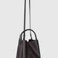 Dark tan nappa leather Victoria Bucket bag with a top handle and adjustable shoulder strap.