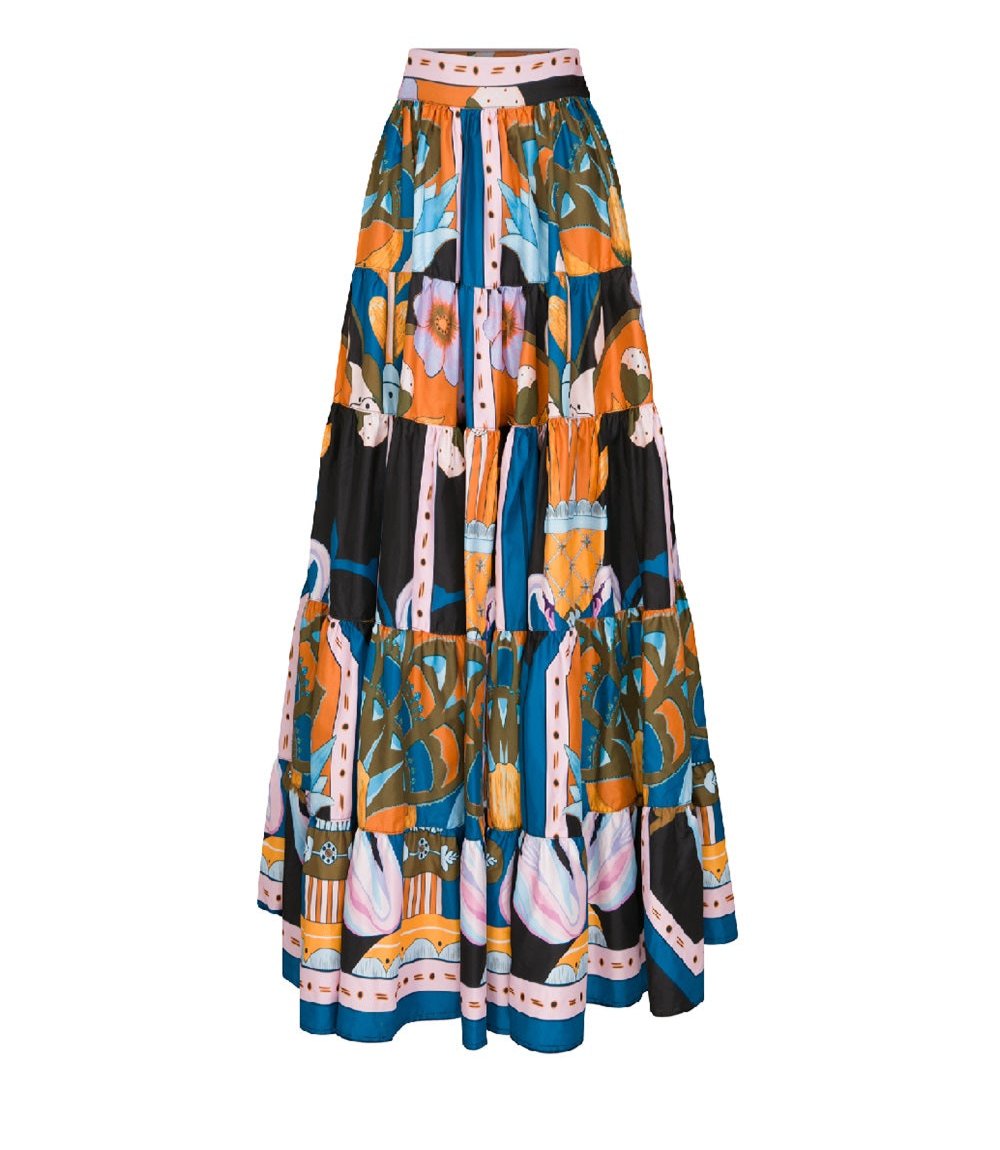 Lug Von Siga Viktoria Skirt by Lug Von Siga is a long, multi-tiered skirt featuring a vibrant, abstract floral and geometric pattern in shades of orange, blue, black, and white.