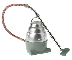 The Maileg Vacuum Cleaner is a small, vintage-style toy with a silver top, green base, red patterned hose, and metallic wand—perfectly sized for mice.
