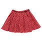 The Girls' Gianna Skirt by Pink Chicken is a red Valentine’s skirt with an elastic waistband and a cute heart print pattern of small black shapes.