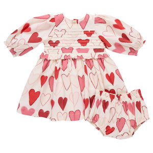 The Pink Chicken Baby Girls' Renee Dress Set features a sweet gradient heart pattern in red and pink on white—perfect for your little one's Valentine’s Day look.