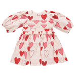 The Pink Chicken Girls' Renee Dress features long sleeves, a cream color with pink and red gradient hearts, and a gathered waist—perfect for Valentine’s Day.