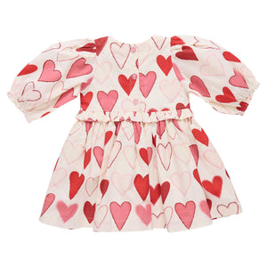 The Pink Chicken Girls' Renee Dress features puffed sleeves and a flared skirt with red and pink gradient hearts on white—perfect for Valentine’s Day.