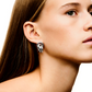 Close-up of a woman's profile showing her ear with a LIÉ STUDIO Vera Earring by Lie Studio against a white background.