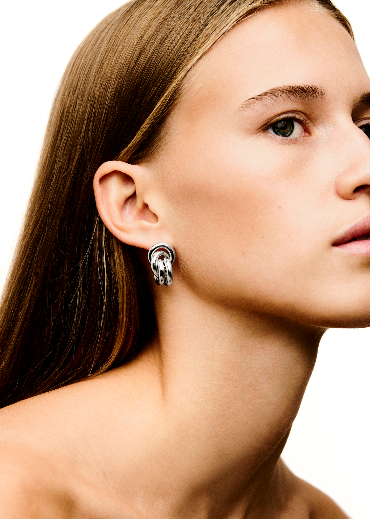 Close-up of a woman's profile showing her ear with a LIÉ STUDIO Vera Earring by Lie Studio against a white background.