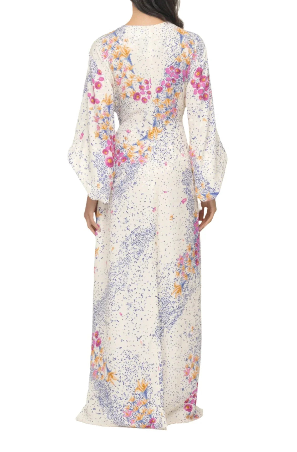 Back view of a person wearing the Agua By Aguabendita Antonieta Maxi Kaftan, a long-sleeve, floral-patterned viscose dress featuring a striking purple and pink design.