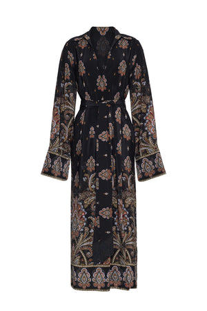 The Viv Midi Dress by Cara Cara features a black paisley and floral print, belted waist, wide cuffs, and a relaxed fit with faux wrap styling.