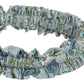 A close-up of the Bonpoint Jovie Headband, crafted from blue organic cotton Liberty fabric, displayed against a white background.