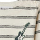 Close-up of Bonpoint's Baby Boys' and Boys' Tourbillon T-shirt in organic cotton, featuring green stripes, two shoulder buttons, and an embroidered electric guitar patch—a stylish choice for nautical-inspired baby clothes.