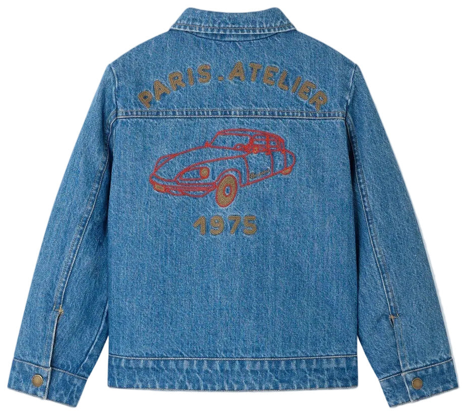 Introducing the Boys’ Marvin Reversible Jacket with Embroidery on the Back by Bonpoint. This blue denim jacket features an embroidered red car motif, with “PARIS ATELIER” above and “1975” below on the back. Crafted from soft organic cotton, it combines style and comfort—perfect for everyday adventures.