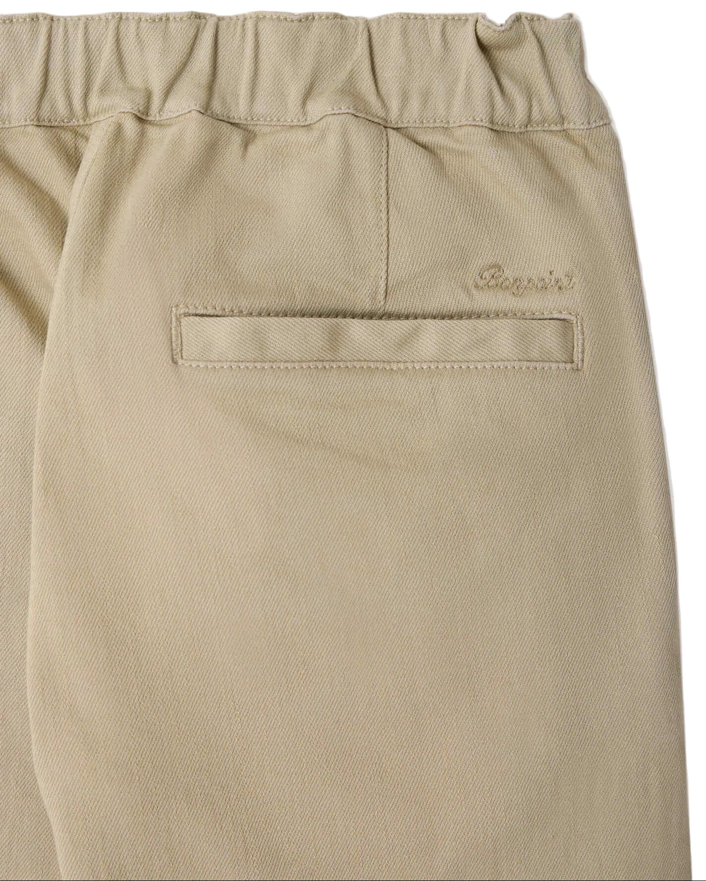 Close-up of Bonpoint Boys’ Maurice Straight Pants crafted from organic cotton, featuring an elastic waistband for added comfort. The back pocket has a horizontal opening with the Bonpoint embroidered logo positioned above it.