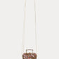 The Girls’ Aimane Travel Bag by Bonpoint is a small floral-patterned handbag crafted from organic cotton, featuring a top handle and a long, thin white strap, displayed against a plain white background.