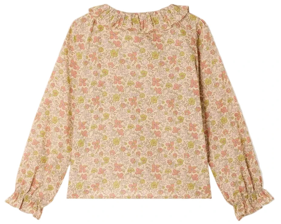 The Girls’ Melusina Blouse in Liberty Fabric by Bonpoint features long sleeves, a ruffled collar and cuffs, and is crafted from luxurious Liberty fabric in soft shades of pink, green, and cream on a light background.