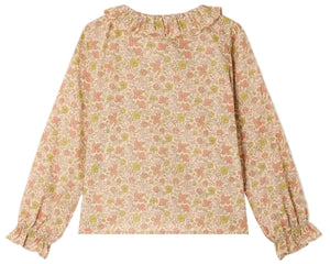 The Girls’ Melusina Blouse in Liberty Fabric by Bonpoint features long sleeves, a ruffled collar and cuffs, and is crafted from luxurious Liberty fabric in soft shades of pink, green, and cream on a light background.