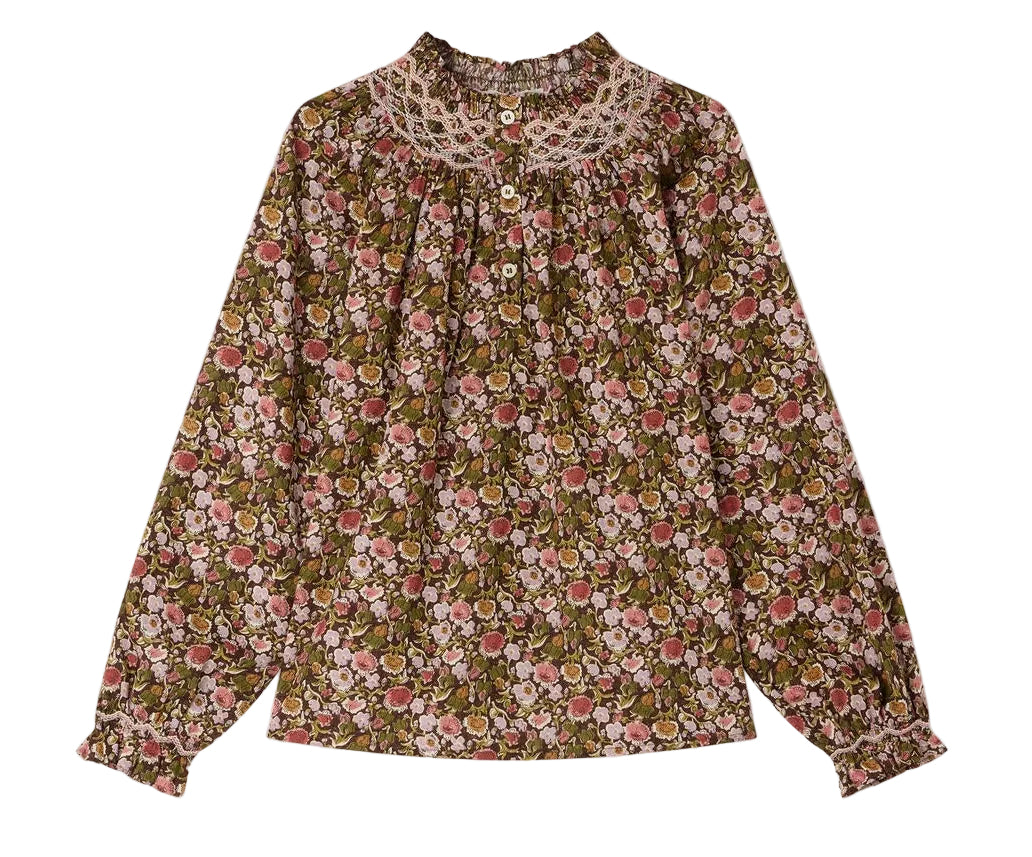 The Girls’ Petale Blouse by Bonpoint is a long-sleeve top made from Liberty fabric, showcasing a multicolored floral print, ruffled cuffs, a lace collar, and front buttons, displayed on a white background.