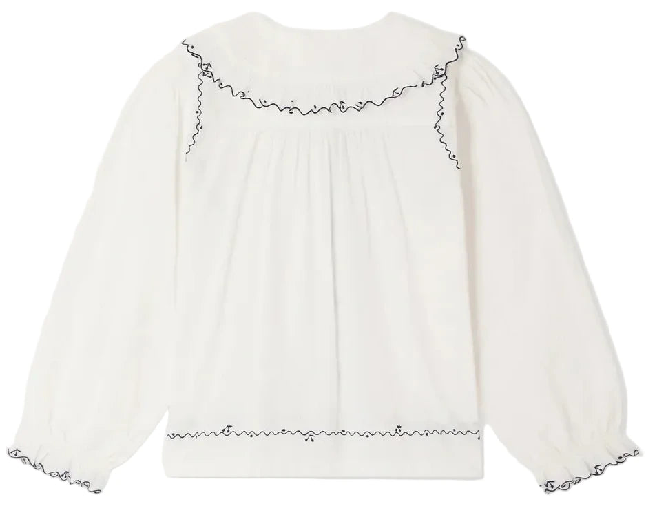 Bonpoint Girls’ Maneke Blouse with Peter Pan Collar Embroidery in white, featuring long sleeves and vintage-inspired black scalloped trim on the embroidered collar, sleeve cuffs, and waist.