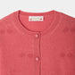 Close-up of the Bonpoint Girls’ Manon Cardigan, featuring a round neckline, cherry embroidery, and matching pink buttons. The signature Bonpoint label with cherries and text is sewn inside the collar, showcasing this cashmere cardigan’s distinctive style.