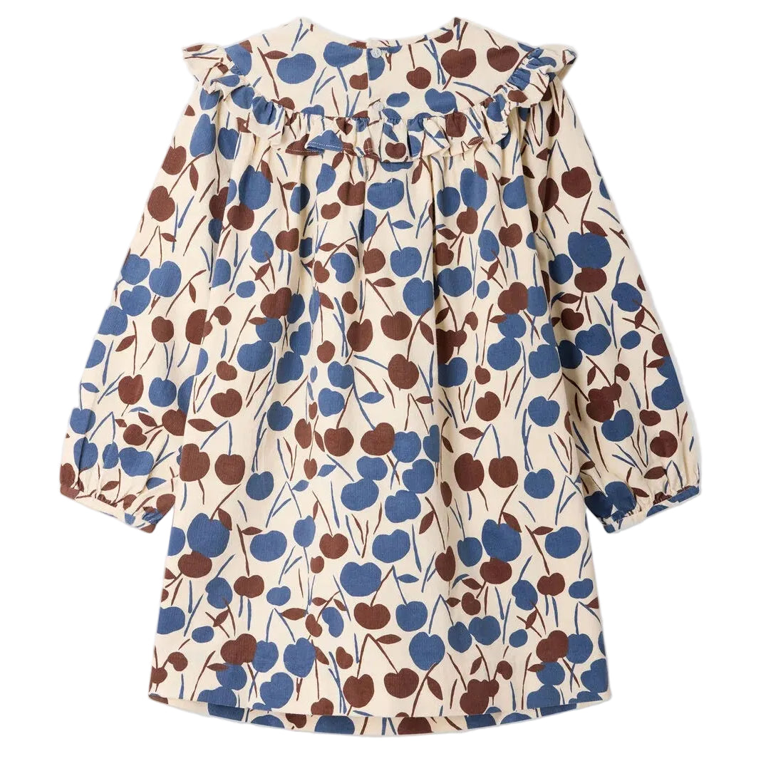 Introducing the Girls’ Bevika Dress in Organic Cotton Velvet by Bonpoint—a long-sleeved dress with a ruffled collar, adorned with a blue and brown leaf pattern on a cream background. Crafted in soft organic cotton velvet, this charming dress offers both comfort and warmth.