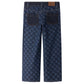 Back view of the Bonpoint Girls’ Minalie Cherry Checkerboard-Print Denim Trousers – wide-leg blue jeans featuring a cherry checkerboard pattern, two back pockets, an adjustable high waist, and a brown leather patch on the waistband.
