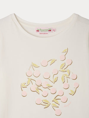 Close-up of the Girls’ Capricia T-Shirt by Bonpoint, crafted from organic cotton and featuring a pink cherry print with a green leaf design on the chest; the collar label displays “Bonpoint.”.